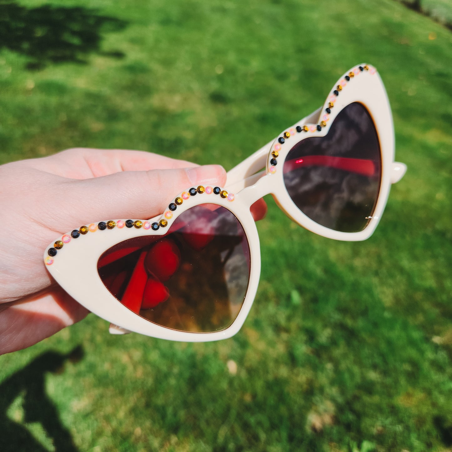 Ivory Heart Shaped Sunnies with Black, Gold, and Multicolor Rhinestone Accents